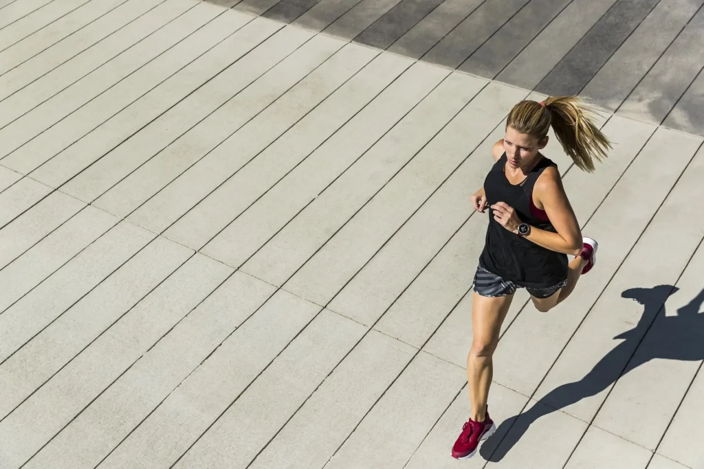 In the image, a girl jogging, seen from above